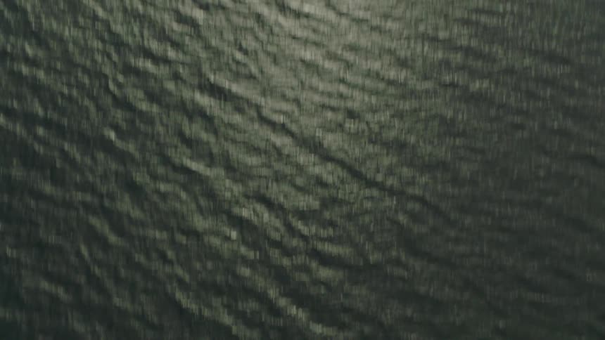 Aerial view of sun shining body of sea water with small island