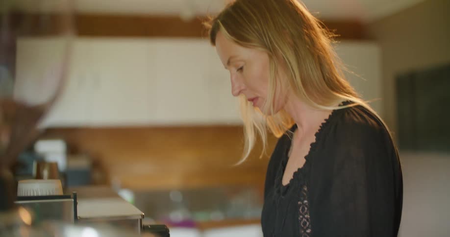 A barista in a coffee shop prepares a beverage