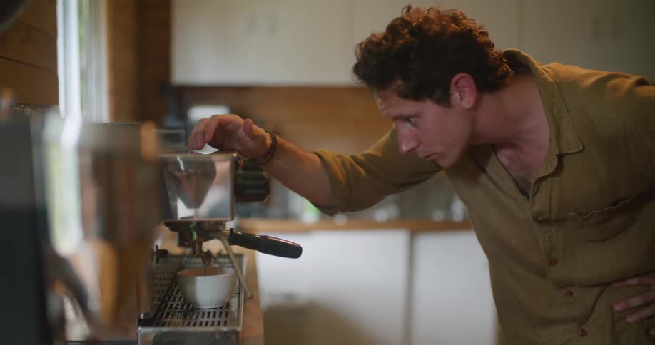 A man making coffee with a machine