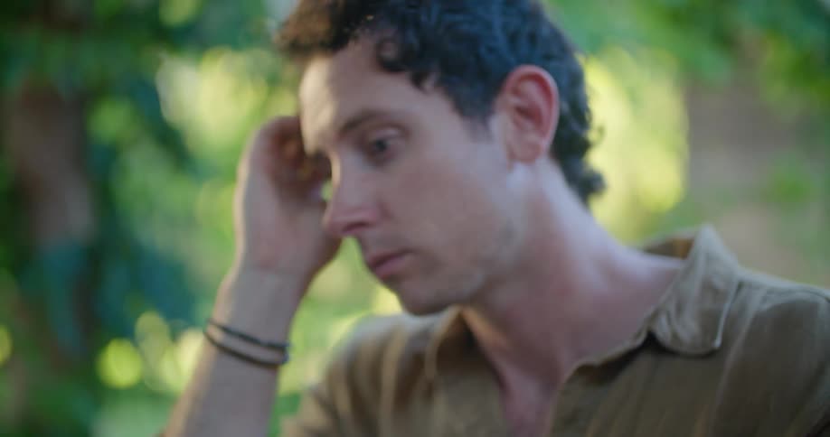 Man typing on laptop outdoors