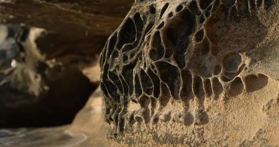 A large rock formation on a beach