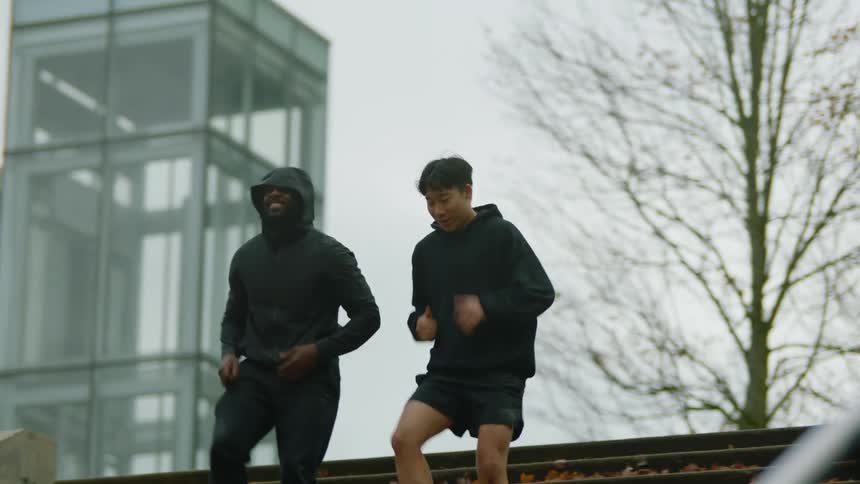 Two men run down the stairs after a rest