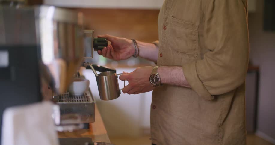 A man brewing coffee with a machine