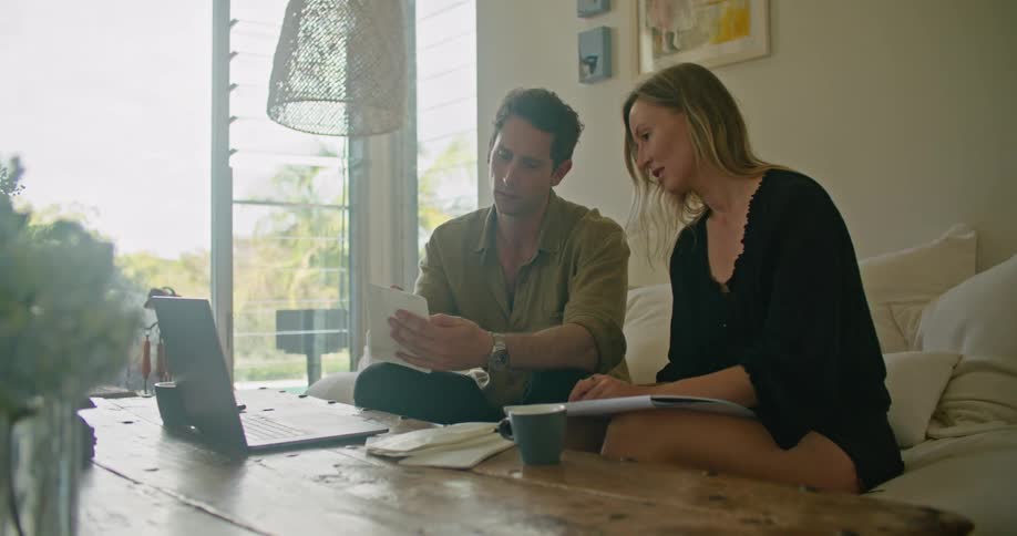 A man and woman talking while sitting on a couch