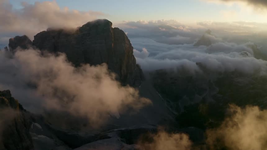 The mountain rises high above the clouds