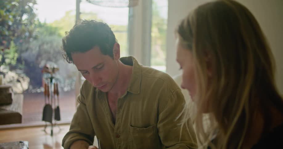 Two people looking over papers in a room