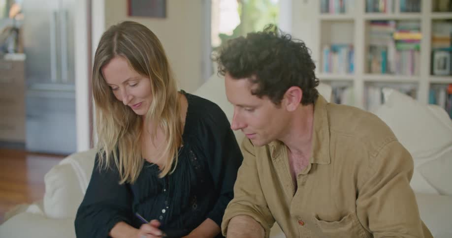 Young couple checking samples while sitting on the couch in the living room