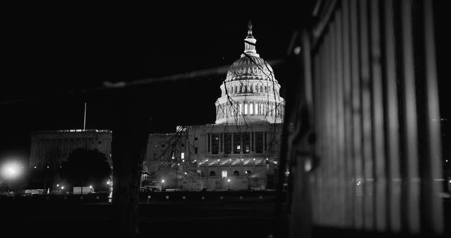 The capitol building at night with the lights on