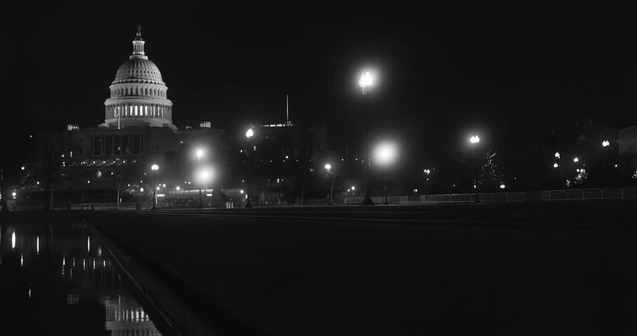 The capitol building at night with the lights on