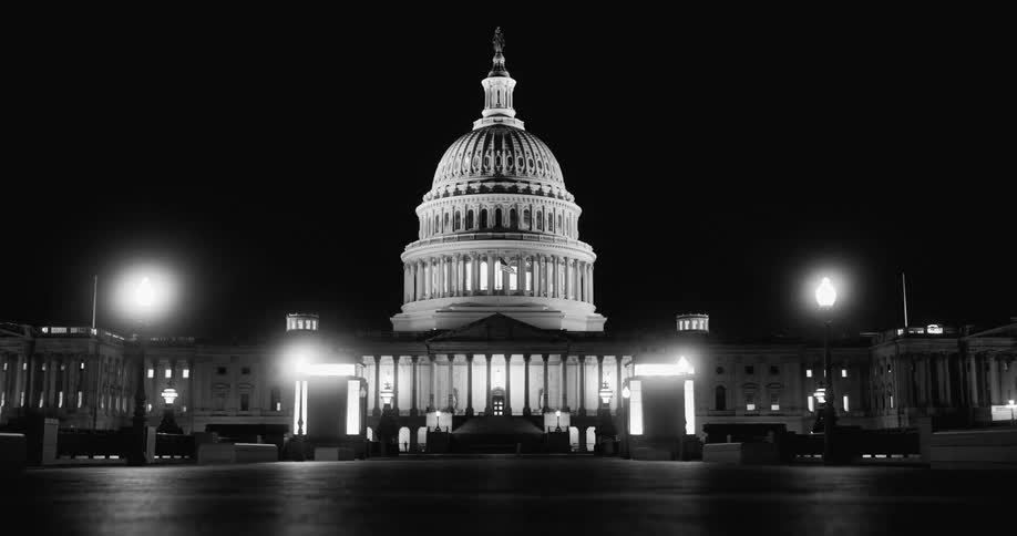 The capitol building at night with the lights on