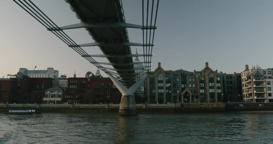 People are standing on the bridge by the city