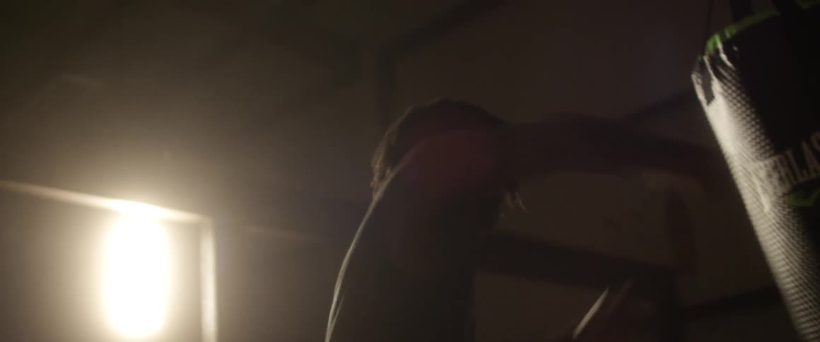 A woman punches a punching bag