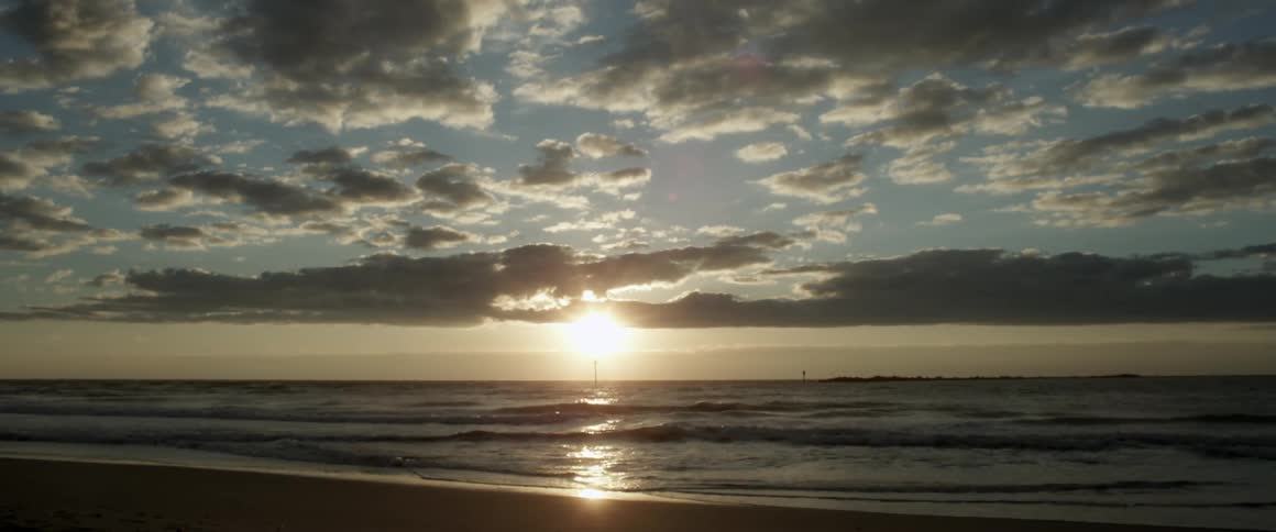 Waves come to shore at sunset