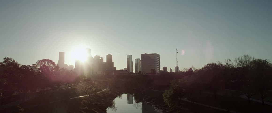 The sun comes up over some buildings
