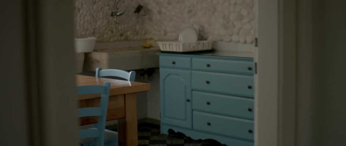 View of a kitchen table, sink and counter