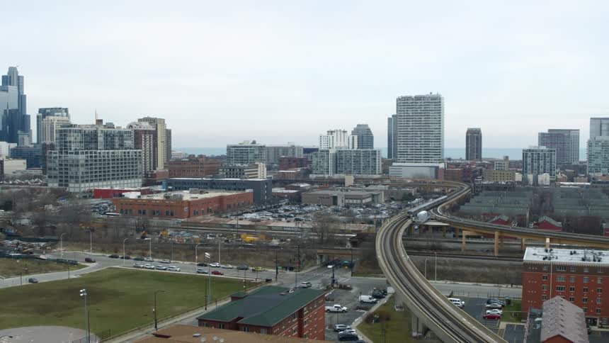 Train winds along overpass toward city center