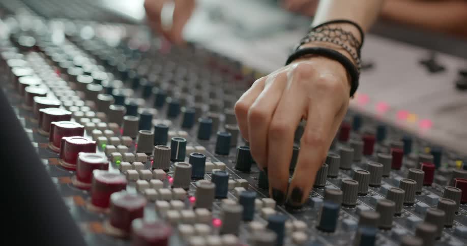 People manipulate dials on control board