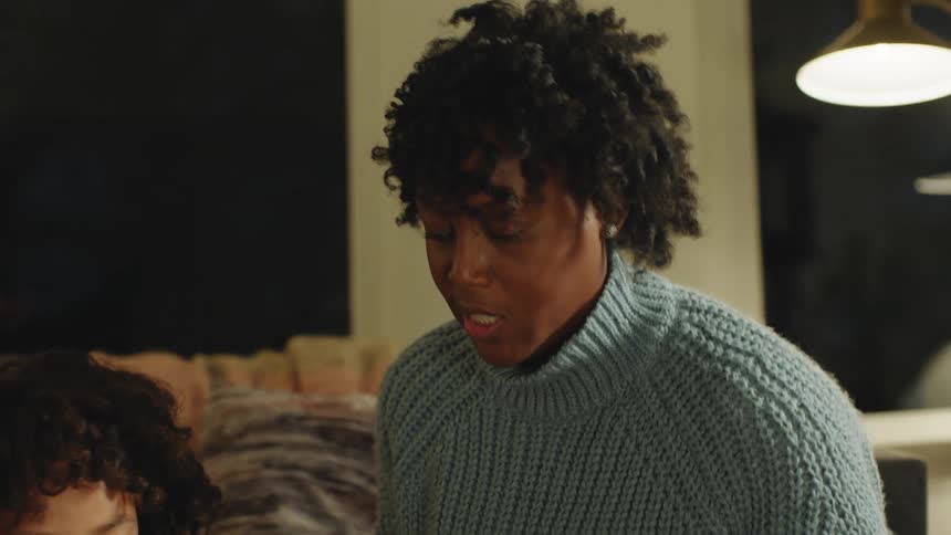 A girl is showing her mom a painting
