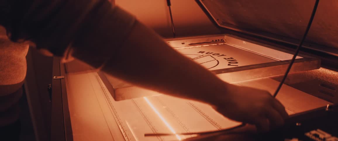Person putting graphic in press