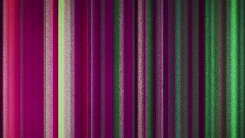 Static on a television screen flashes pink purple and green lines
