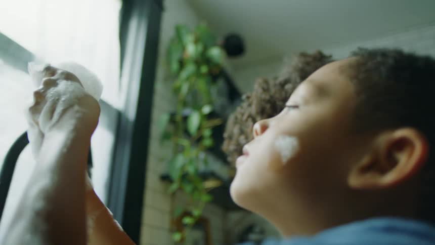 Children play with bubbles in the sink