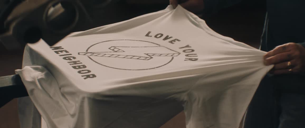 Person pull graphic t shirt off machine platform
