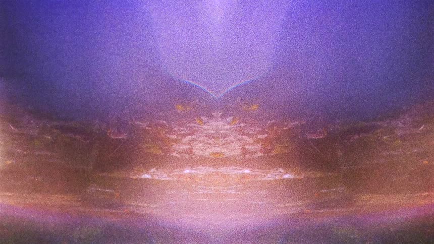 Abstract mirror reflected footage of a river near a forest with lens flares