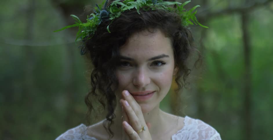 A woman smiles while looking around