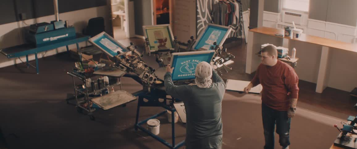 Two men working on a screen printing workshop