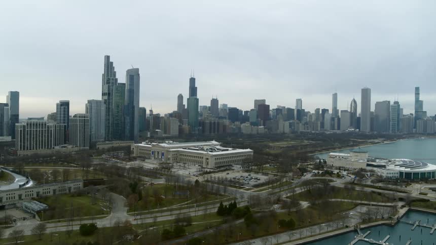 Aerial view of the skyscrapers on the skyline of a waterfront city at evening