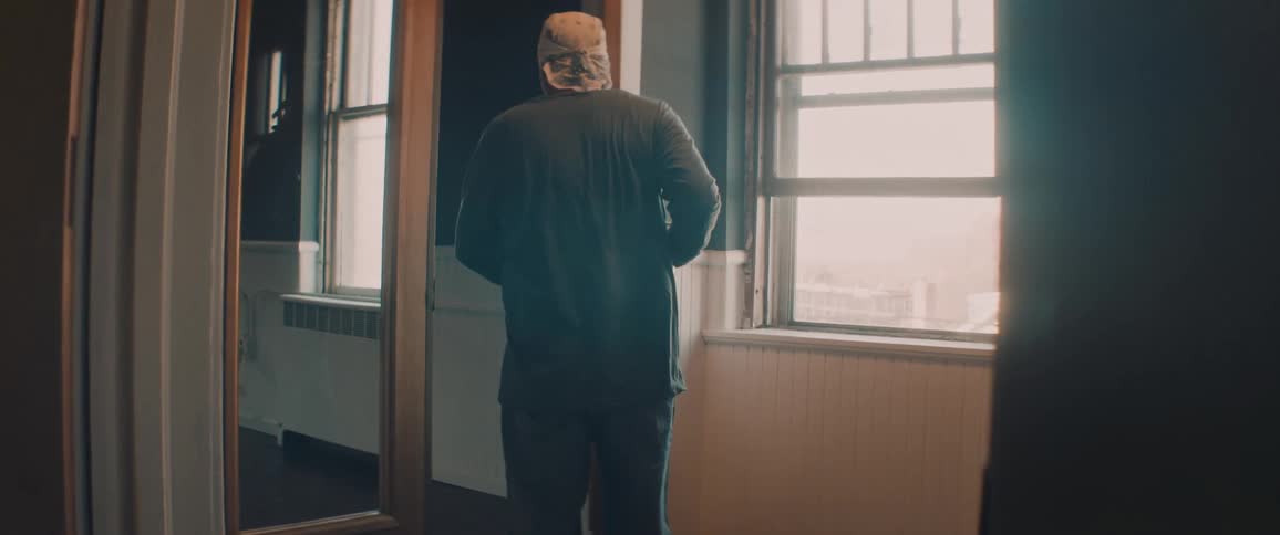 Man carrying to go cup opens locked glass door with key