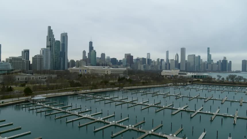 Empty marina next to the skyscrapers on the city skyline caught on vintage film