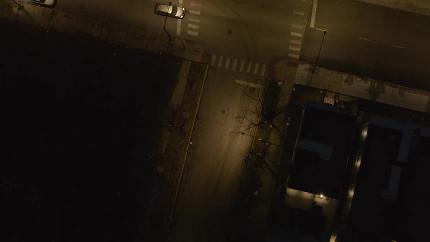 Aerial view of city intersection with vehicles at night