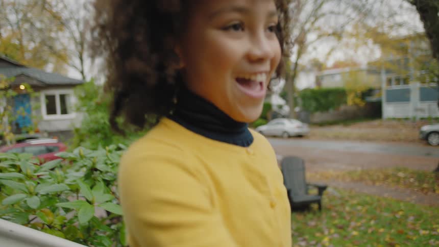 Black child picking up leaf