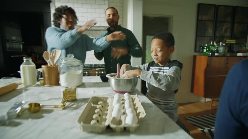 Mother rushes to prevent son from throwing another handful of flour from baked good recipe at his sister