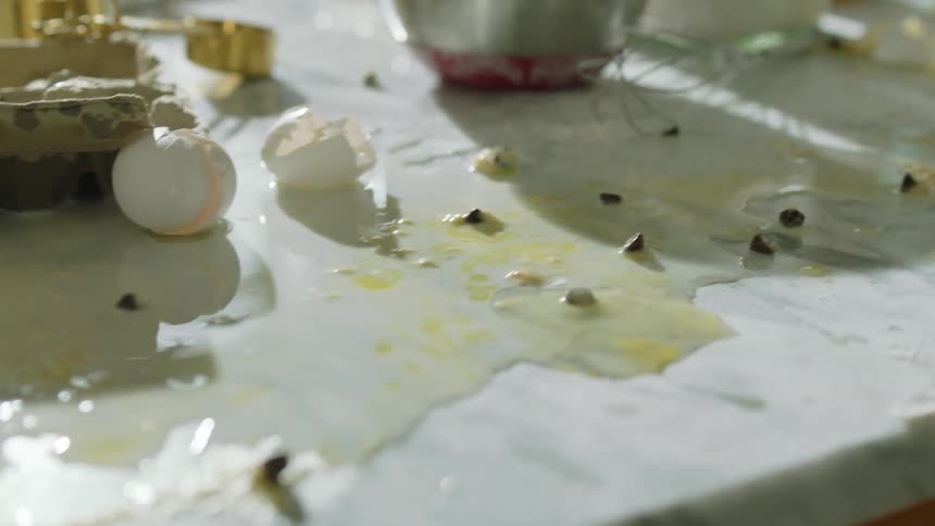 There are broken eggs and spills all over the table