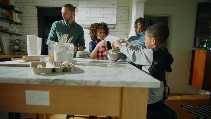 A family baking cookies in a room