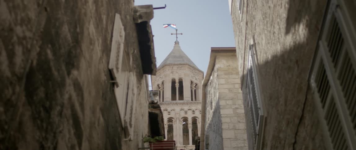 An alley is surrounded by stone buildings