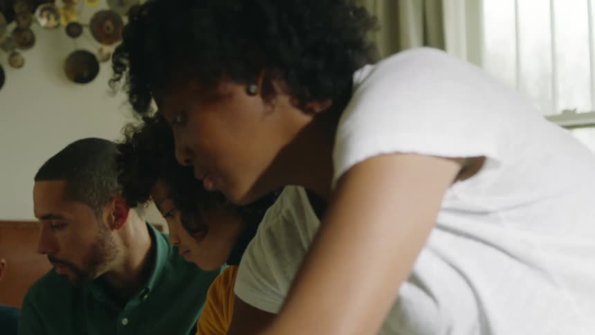 Family puts away toy pieces in bedroom