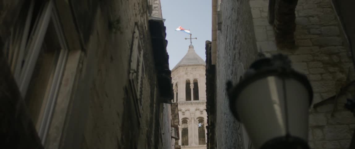 The narrow distance between two buildings with another building in the background
