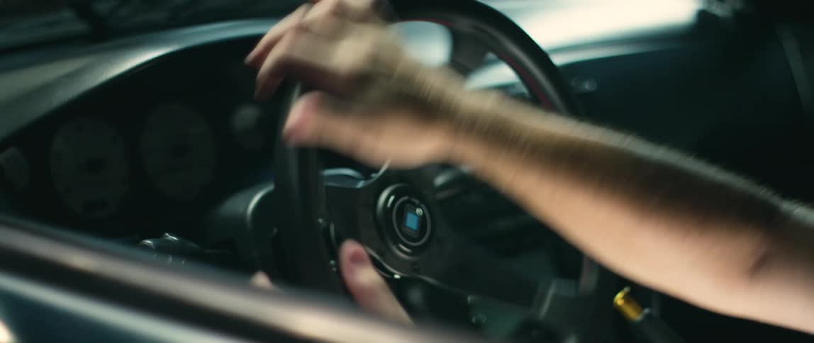 Worker attaches steering wheel to car