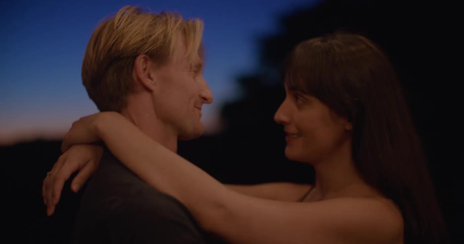 Couple kissing outdoors at night