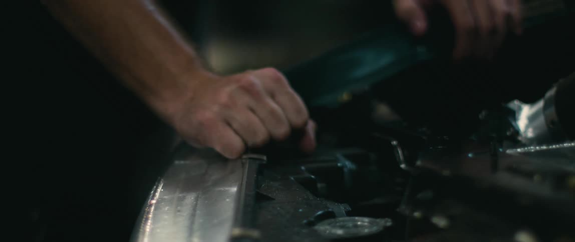 A man is working on the car engine
