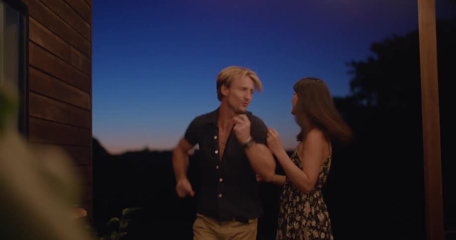 A couple dance on their porch together
