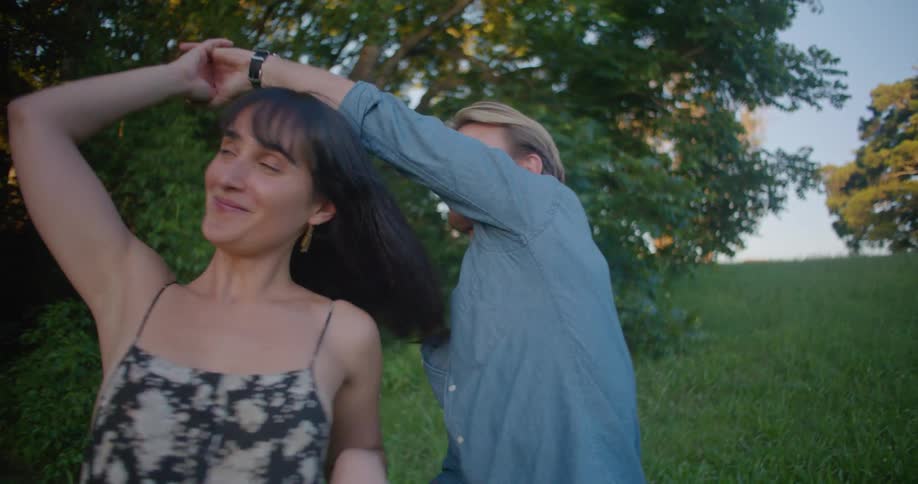 A couple dance and kiss outside