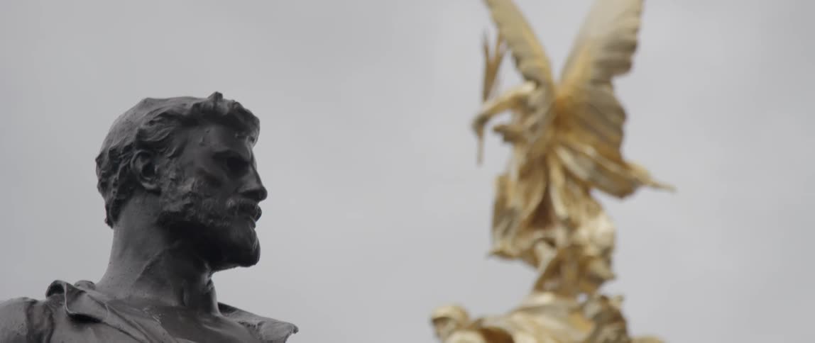 Two statues on a cloudy day