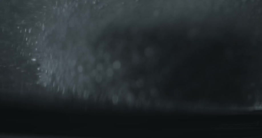 Soap bubbles float down into water