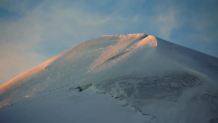 Mound contrasts with cloudy sky