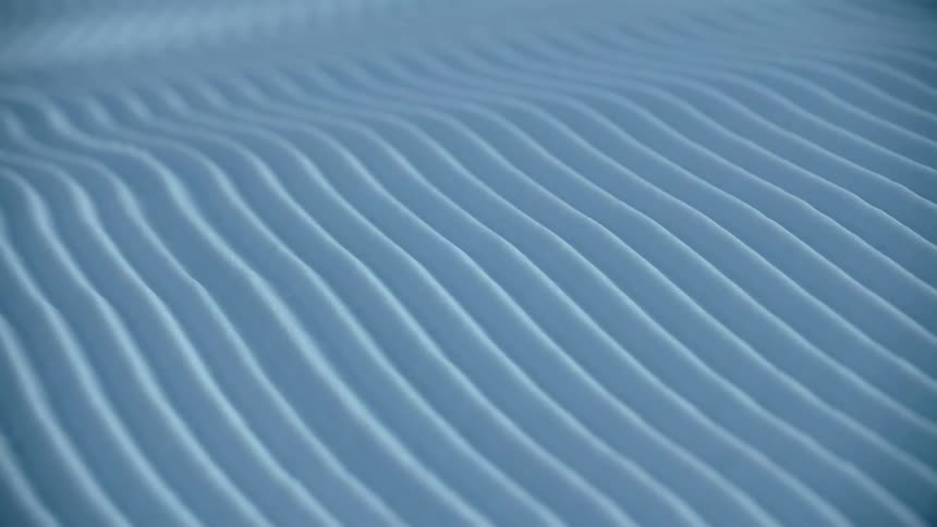Abstract footage of uniform lines in sand