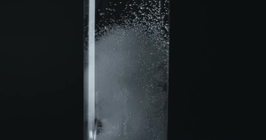 Bubbles spin in a glass water container